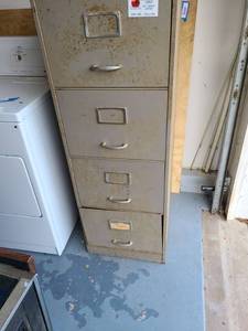 lot 3001 image: Metal file cabinet. 52 x 18 x 25. Been in garage (little dirty) and fairly heavy. You may need help loading.
