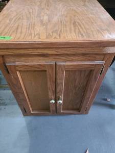 lot 3042 image: Wooden cabinet. 31 x 25 x 27. Top isnt secured