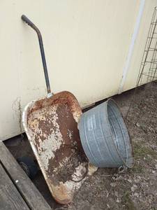 lot 4100 image: Galvanized tank bucket with wheel barrow planter