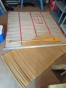 lot 4126 image: Caviness Woodworking Co. wooden oar with roll out bamboo mats (6 metal yard stick is for reference only)