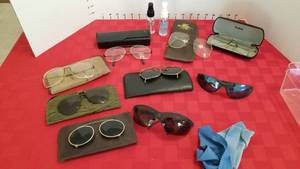 lot 1585 image: Glasses and clip on sunglasses and cleaner