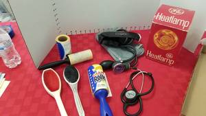 lot 1595 image: Omron arm cuff, stethoscope, lint brushes and heat lamp