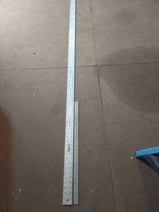 lot 4267 image: Exact metal 72 in yard stick with 24 in metal measuring stick