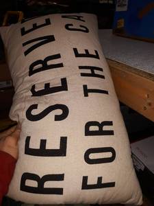 lot 37143 image: tan pillow with writing on it