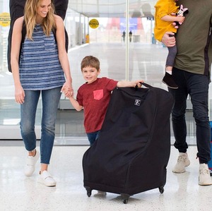 lot 576 image: J.L. Childress Spinner Wheelie Deluxe Car Seat Travel Bag, Black,One Size