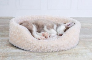 lot 232 image: Furhaven Pet Bed, Medium, Oval Cuddler Supportive Dog Bed