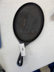 lot 25 image: Unmarked oval cast iron skillet