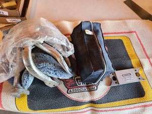 lot 1063 image: Miscellaneous motorcycle parts. Cycle care with bag. Super brace, face shield,, seat cover and tire brackets. Plus a throw rug