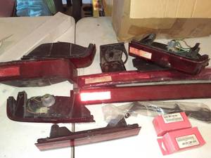 lot 1106 image: Miscellaneous motorcycle parts for Honda Goldwing. Mostly tail lights, there is also a kickstand and bulbs