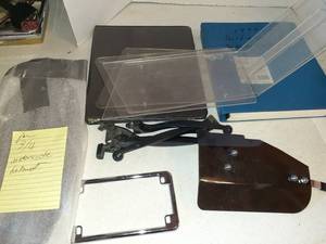 lot 1107 image: Honda Goldwing manuals, levers, shields, and 34 shield for helmets