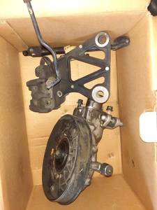 lot 1112 image: Honda Goldwing parts.. Brake caliper, kick stand with spring and more