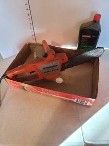 lot 1167 image: Remington electric limb and trim chainsaw and chainsaw lubricant