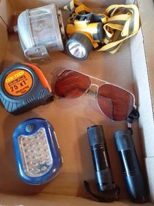 lot 1385 image: Flashlights and more. A headlamp, flash lights, pencil sharpener and glasses