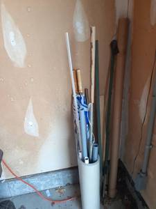 lot 2000 image: Miscellaneous garage items. Metal poles, fence posts (3) and 2 large umbrellas