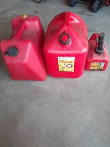 lot 2002 image: (2) 5 gallon gas cans plus a (1) gallon can