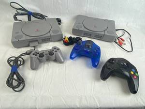 lot 7658 image: Lot of 2 Sony Playstation Game Consoles w Attachments and Controllers Shown