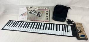 lot 9107 image: Soft Keyboard Piano - 61 Keys - Hand Roll Piano - 61KII - w Accessories in Original Box wpapers - NEAT