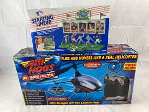 lot 9108 image: Starting line Up Collectors Stand and Air Hogs RC Copter