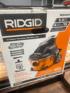 lot 424 image: RIDGID 4 Gallon 5.0-Peak HP Portable WetDry Shop Vacuum with Fine Dust Filter, Hose and Accessories, OrangesPeaches