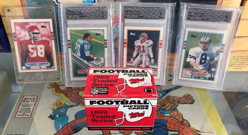 lot 1008 image: 1989 Topps Traded Football Set - Graded Rookies of Barry Sanders, Troy Aikman, Deion Sanders  1st Ever Derrick Thomas Rookie Card - Must See