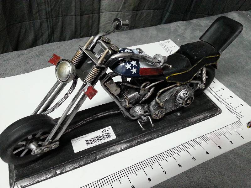 lot 1032 image: A really wild metal sculpted Captain America themed motorcycle on a display stand for your desk