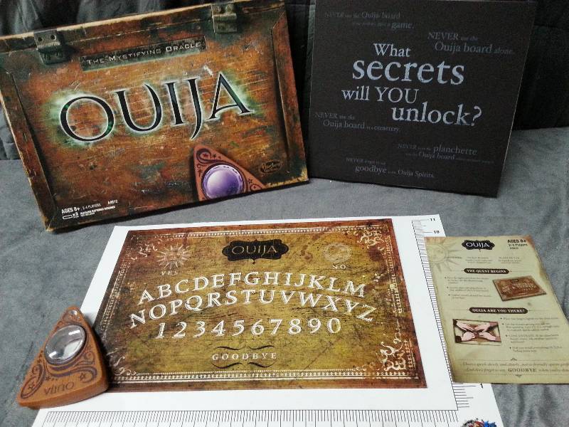 lot 1006 image: Dont play alone with this Ouija Board with a battery power lighted game piece.