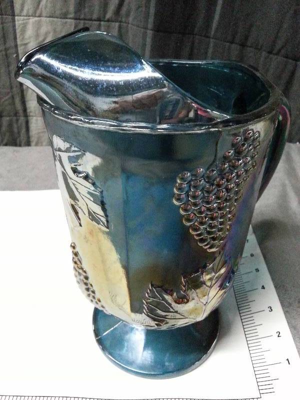 lot 1003 image: Again a very heavy Carnival Glass grapes and leaves wild colors theme pitcher