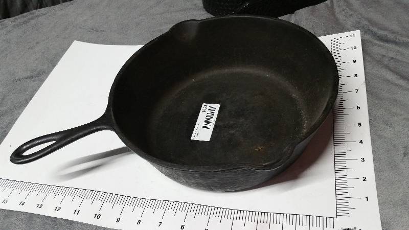 lot 1023 image: Serious, heavy and very deep is this one piece cast iron skillet