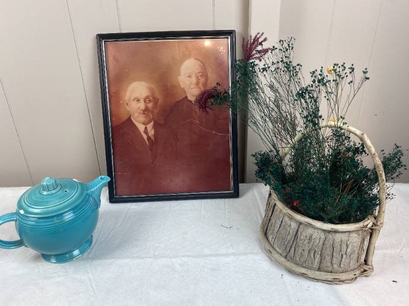 lot 6277 image: Vintage Picture w Frame, Wicker Basket, w Greenery, & FIESTA Blue Creamer, sm Chip on lid, see pic