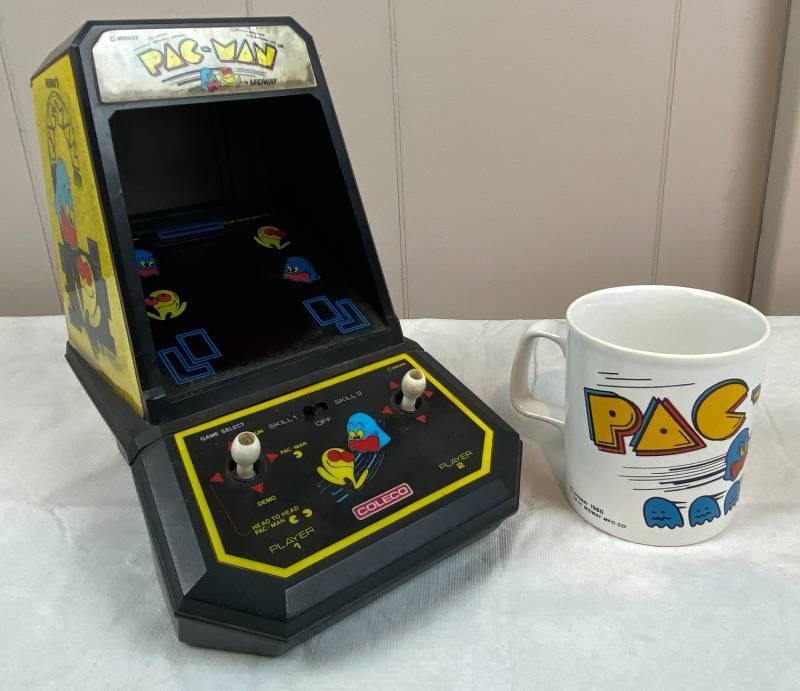 lot 6319 image: Vintage Coleco Pac-Man Hand Arcade Game &amp Pac-Man Coffee Cup