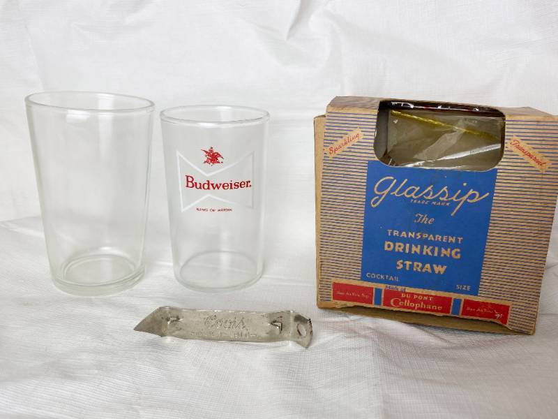 lot 6349 image: One Vintage Budweiser Bow tie Small Beer Glass, Coors Church Key Can Opener, Clear Vintage Glass and Box of Vintage Dupont Glassip Cocktail Straws