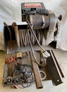 lot 6248 image: WARN WINCH 8274 - 8000LB Capacity - This has a hitch mount and is on a custom made rolling stand to roll right up to your truck w cable cover