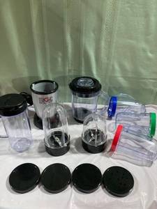 lot 9818 image: Magic bullet with the blender. 3 cups 1 lg cup Assorted lids
