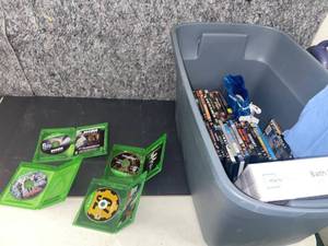 lot 1314 image: 30 gallon tote with contents  video games and DVDs, new shorts etc