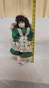 lot 3064 image: Doll on Stand wearing green Christmas dress
