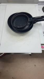 lot 27155 image: (3) Frying Pans and a White Cutting Board