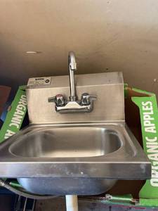 lot 4230444 image: small wall mount Krowne Stainless steel hand wash sink with faucet and tail piece used, no wall bracket