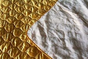 lot 31520 image: gold quilted satin bedspread
