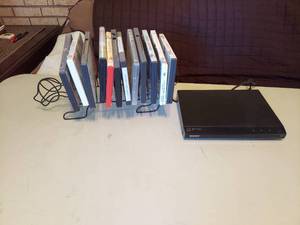 lot 5705 image: Sony DVD Player and DVDs in Rack