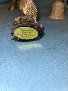 lot 33051 image: Two silver plated eagle figurines about 5 inches tall and eagle bell (no clapper)