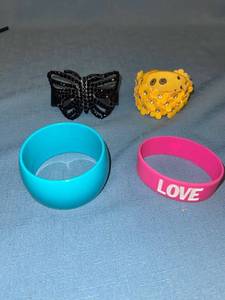 lot 33088 image: 4 bracelets - 2 are leather, 1 plastic, and 1 rubber