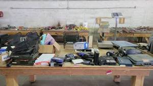 lot 15183 image: Contents of Table - Boston 2612 Paper Cutter, TCS System Electric Scale, Uline 250lb Capacity Scales Model H-104, Linksys Cable  DSL Routers, and More