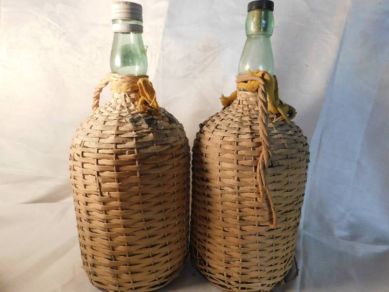 2 large empty wine bottles covered in raffia Streeter Wilkie Funk