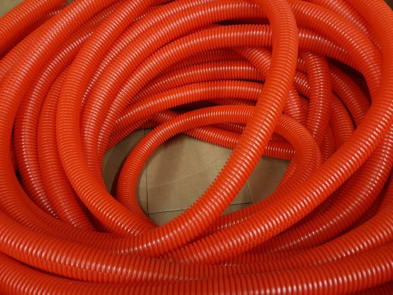 lot 8528 image: NEW 25 foot roll of 34 ID convoluted plastic wire covering tubing supposed to be Red but looks Orange to me