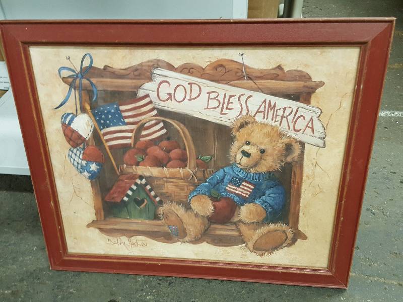 lot 8662 image: God Bless America framed Teddy Bear in a wood framed glass front hanging 23 X 19