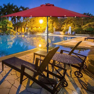 lot 24789 image: CASAINC - 10 ft. Metal Market Solar Tilt Patio Umbrella in Red with Crank and LED Lights - Retail $210.80
