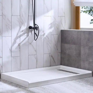 lot 24868 image: WOODBRIDGE  - (48 in. x 32 in.) Solid Surface Single Threshold Right Drain Shower Pan with Stainless Steel Linear Cover in White - Retail $285.00