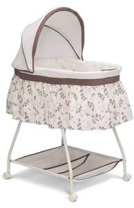 lot 28905 image: Delta Children Deluxe Sweet Beginnings Bedside Bassinet - Portable Crib with Lights and Sounds, Falling Leaves