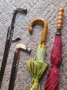 lot 1032 image: Two antique umbrellas missing fabric, believed to have ivory handles. Two other umbrellas, brass bucket, see pictures