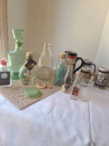 lot 1049 image: Scholl qt. glass milk bottle, milk bottle lids, liquor decanter and bottles, Budweiser and Avon mugs
